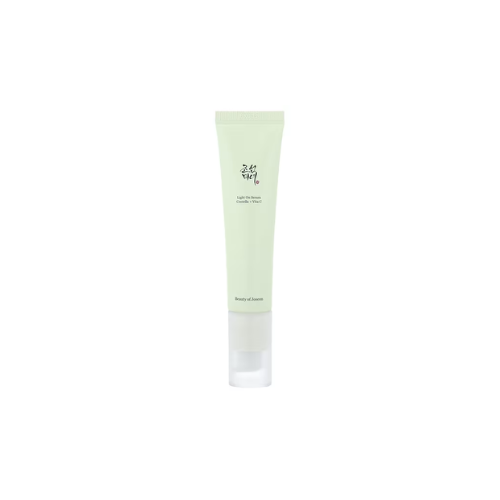 Green skincare tube with white cap on a white background
