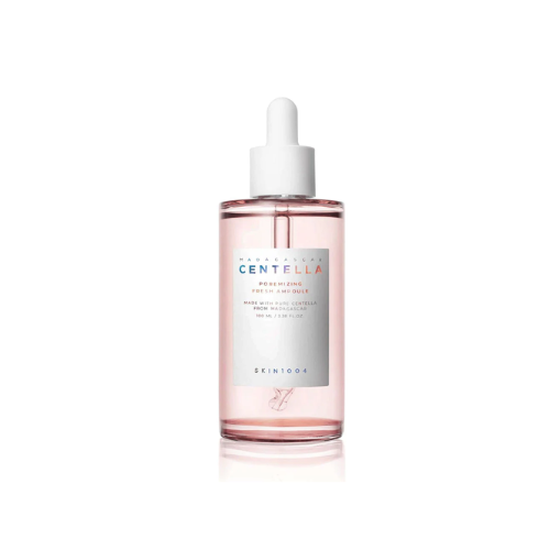 Skincare bottle with pink liquid and white cap on a white background